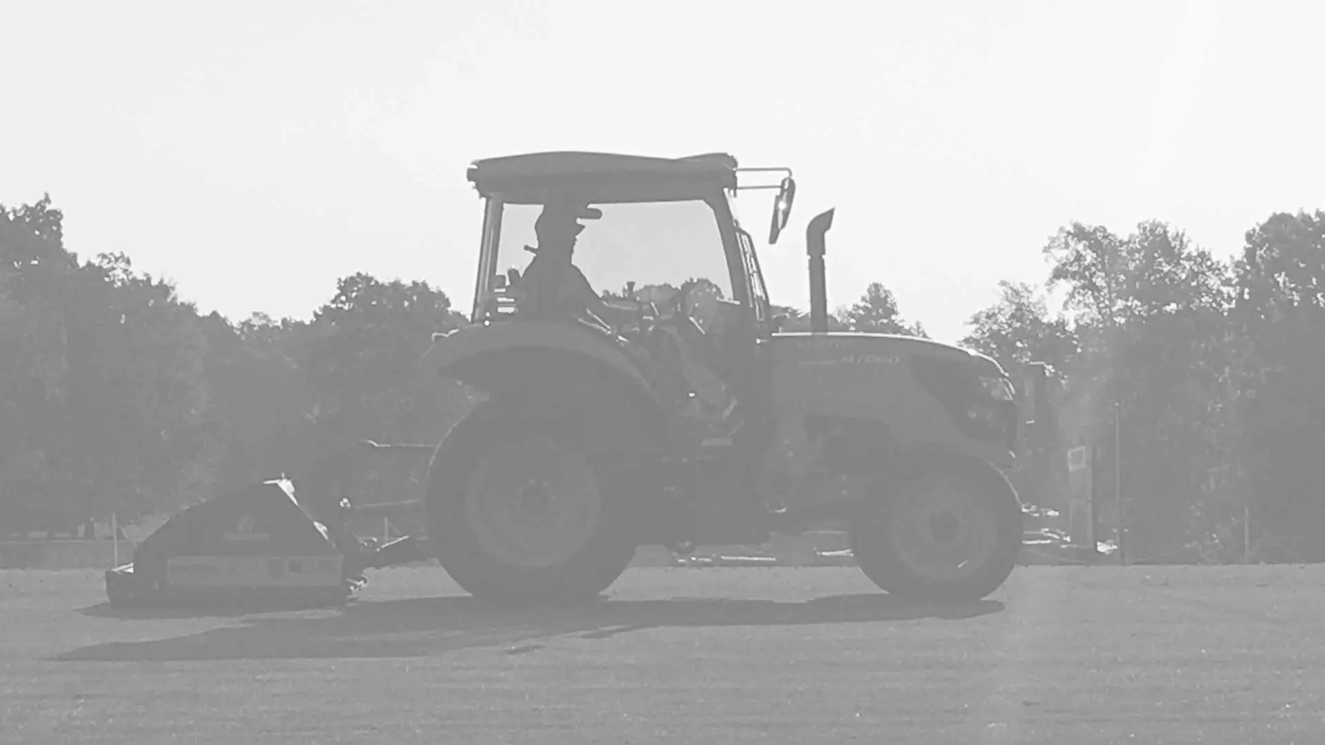 Anderson Turf Management tractor aerating a field in Roanoke.