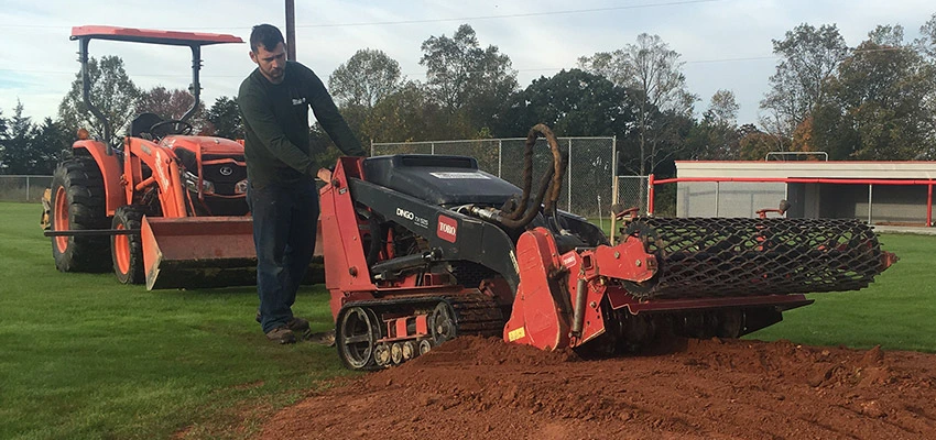 Employee workin on baseball field. /></p><div class=